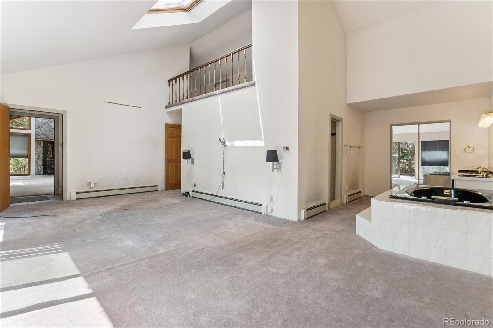 3909 County Road 72 Bailey, CO 80421 - Photo 12 of 50 a view of a livingroom with wooden floor and kitchen view