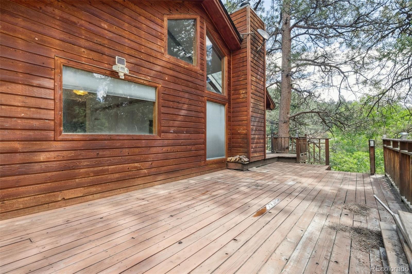 3909 County Road 72 Bailey, CO 80421 - Photo 26 of 50 a view of a house with a backyard