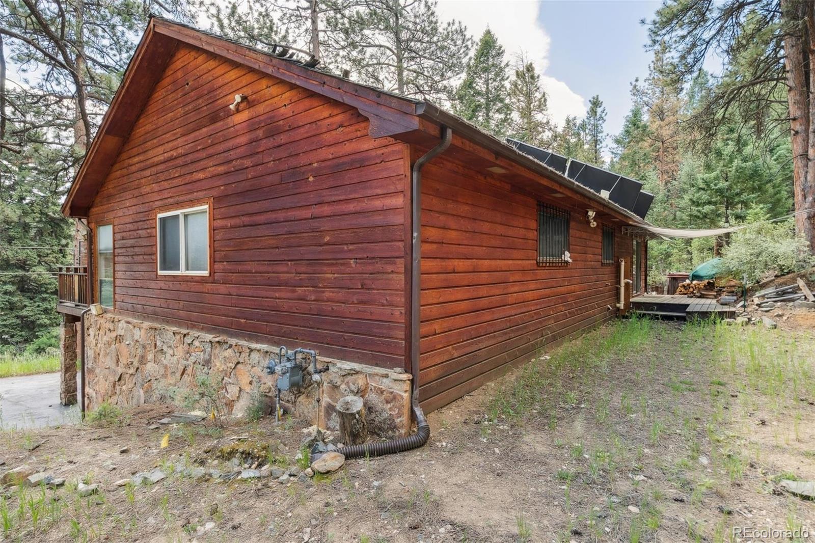 3909 County Road 72 Bailey, CO 80421 - Photo 27 of 50 a view of a house with a yard