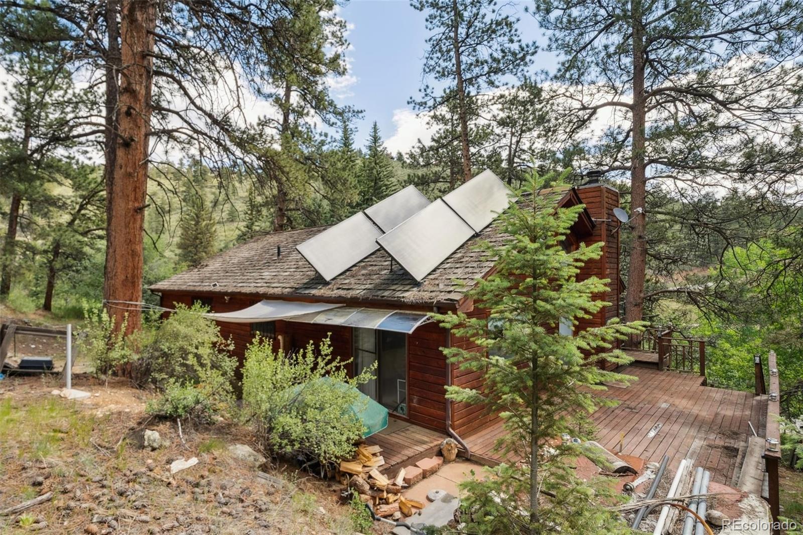 3909 County Road 72 Bailey, CO 80421 - Photo 29 of 50 a aerial view of a house with a yard and sitting area