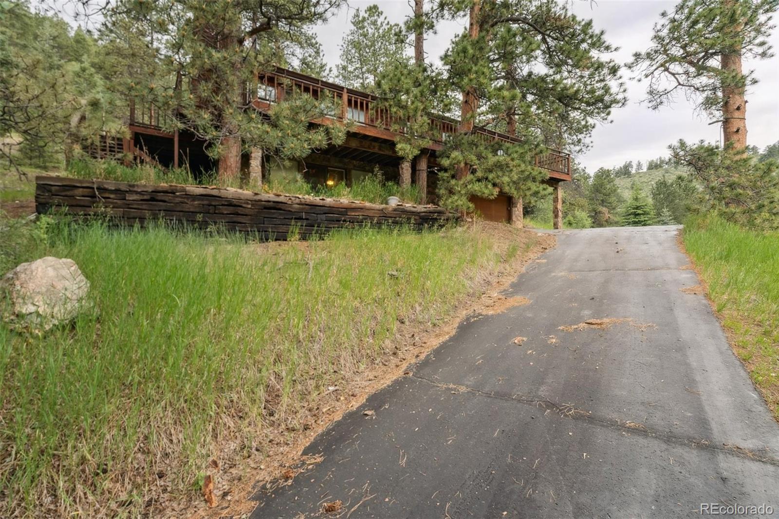 3909 County Road 72 Bailey, CO 80421 - Photo 32 of 50 a front view of a house with a lake view