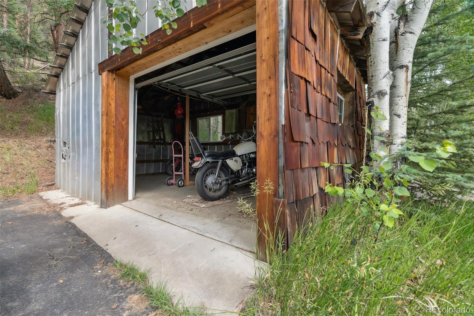 3909 County Road 72 Bailey, CO 80421 - Photo 44 of 50 a view of a house with a patio and a yard