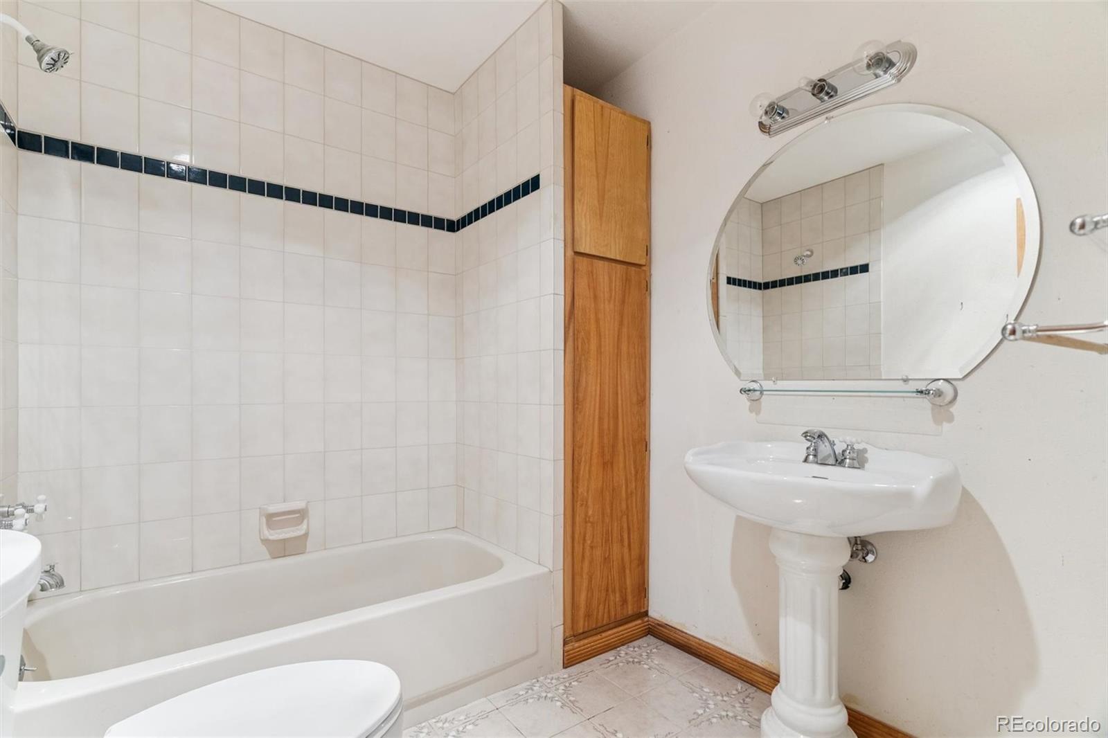 3909 County Road 72 Bailey, CO 80421 - Photo 10 of 50 a bathroom with a sink a mirror toilet and bathtub