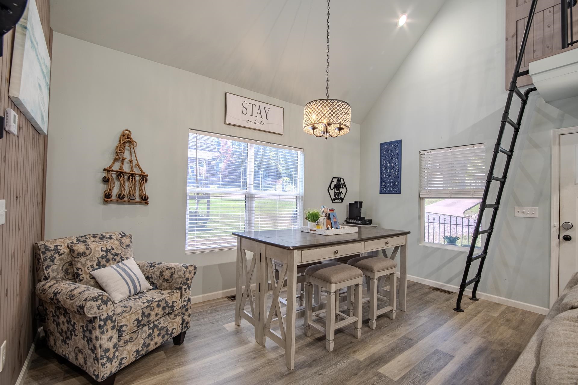 25 Bogey Loop Counce, TN 38326 - Photo 8 of 37 Dining area featuring high vaulted ceiling, plenty of natural light, wood finished floors, and a chandelier