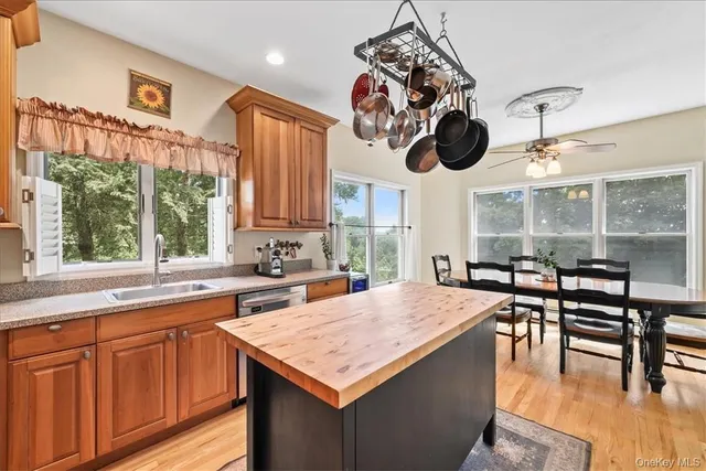 a kitchen with a table chairs and a window
