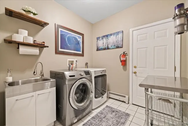 a view of a storage and utility room with washer and dryer