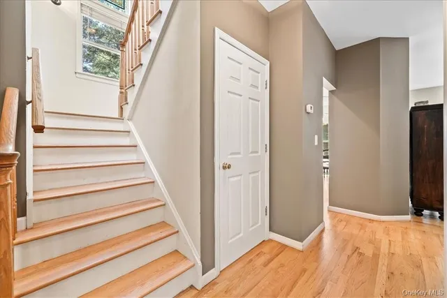 a view of entryway with wooden floor and stairs