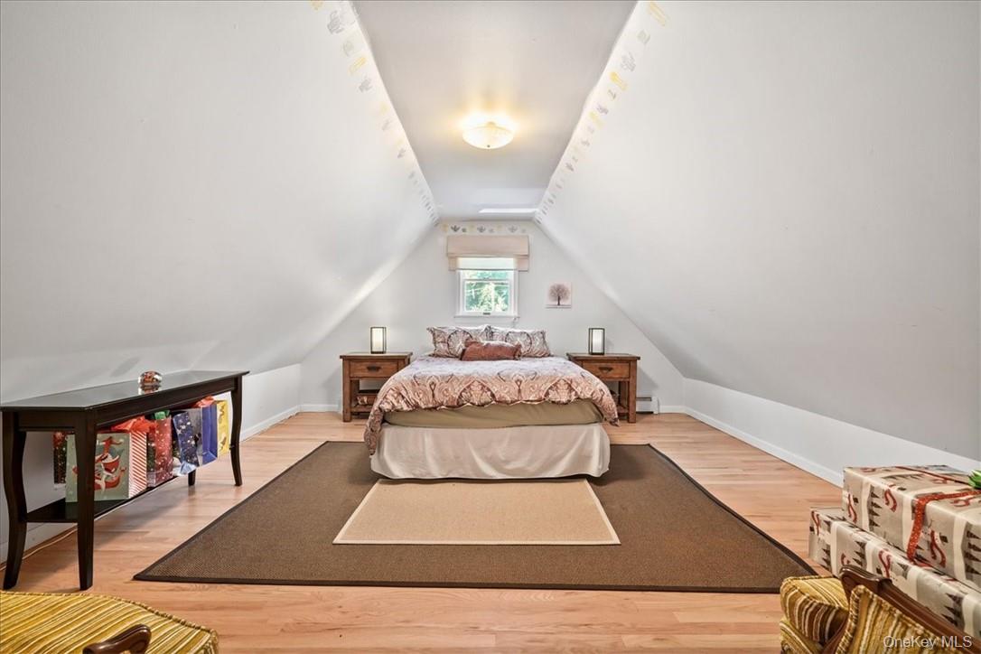 613 Rte 9W Piermont, NY 10968 - Photo 24 of 37 a bedroom with a bed a rug and book shelf