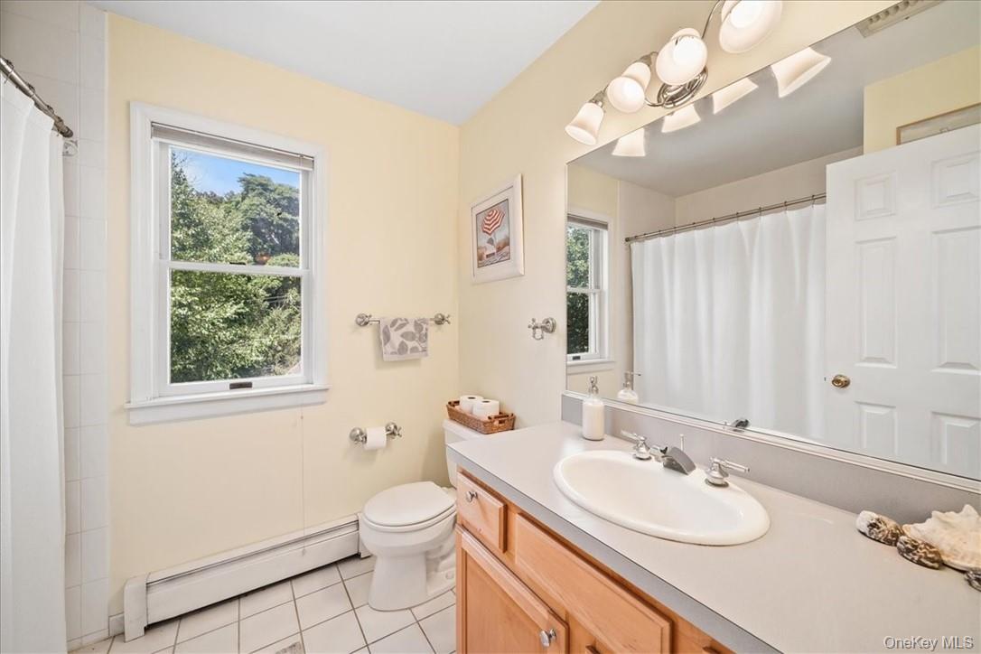 613 Rte 9W Piermont, NY 10968 - Photo 25 of 37 a bathroom with a granite countertop sink a toilet and a mirror