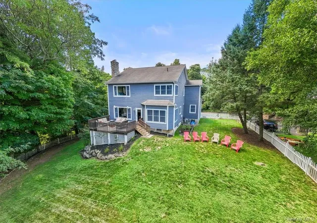 a front view of a house with a garden and yard