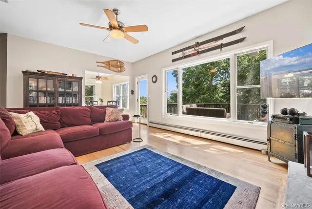 a living room with furniture a large window and a table