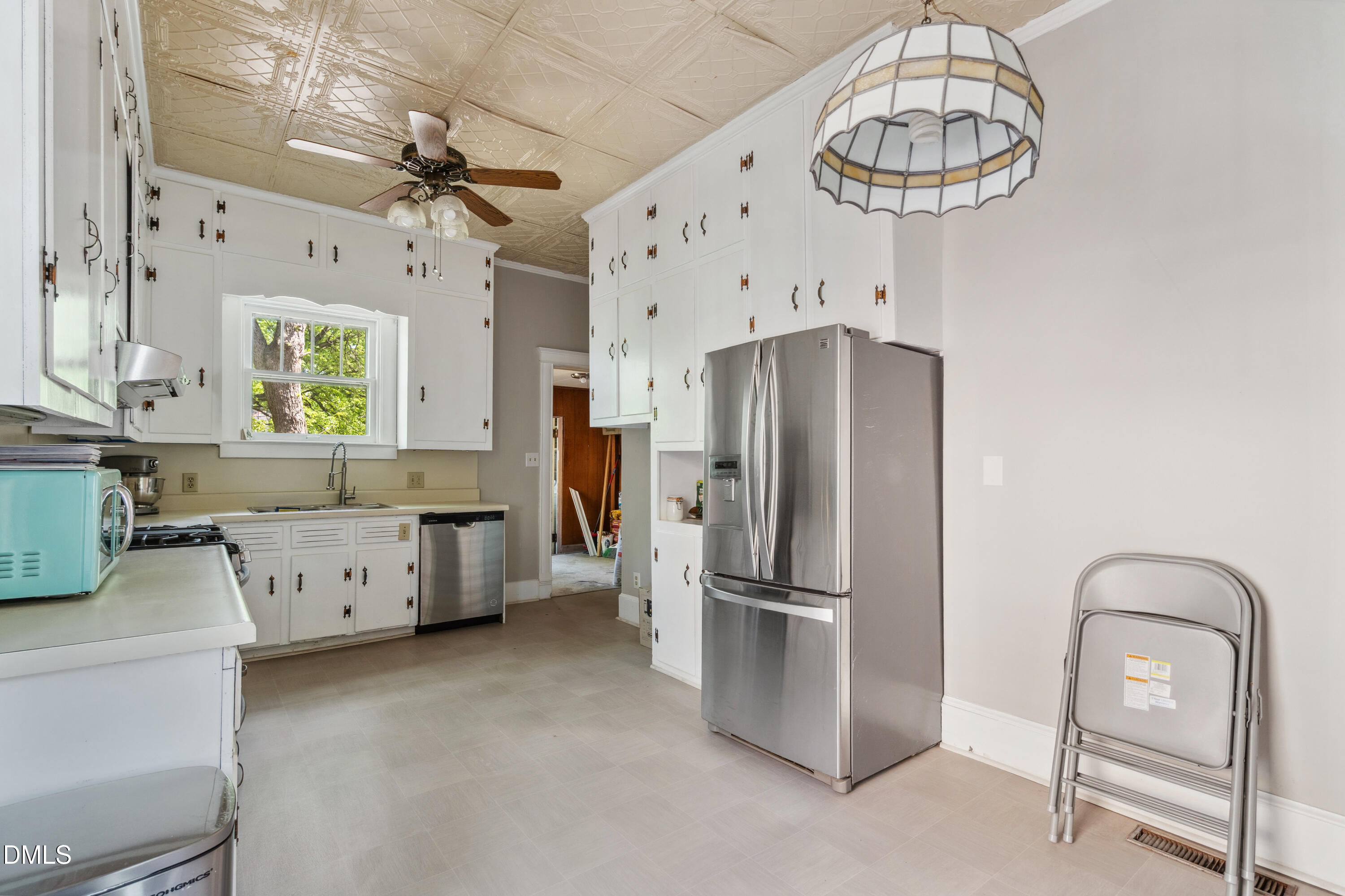 116 Hawthorne Road Raleigh, NC 27605 - Photo 21 of 61 a kitchen with stainless steel appliances a refrigerator and a chandelier