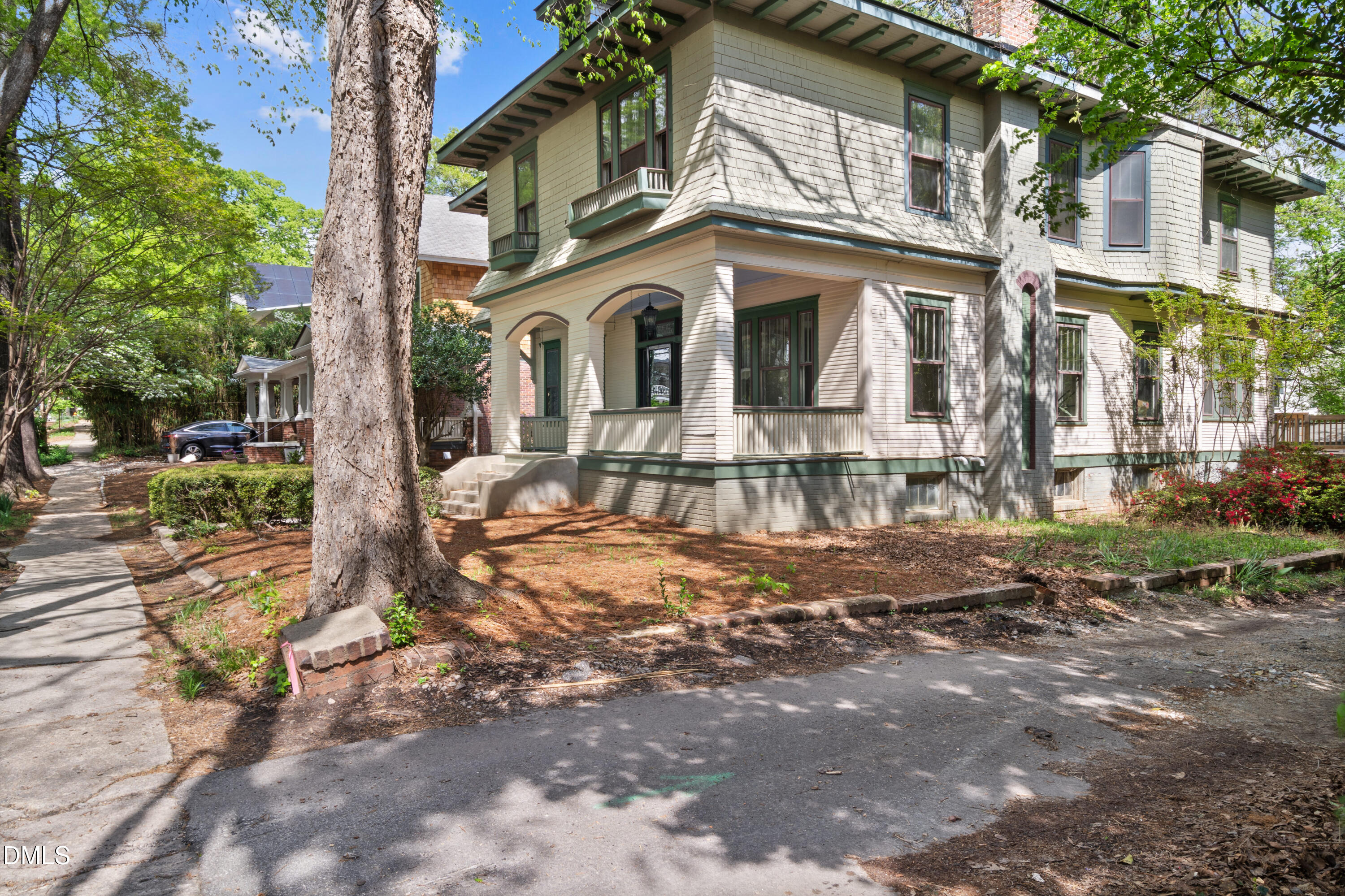 116 Hawthorne Road Raleigh, NC 27605 - Photo 4 of 61 a view of a white house with large windows next to a road