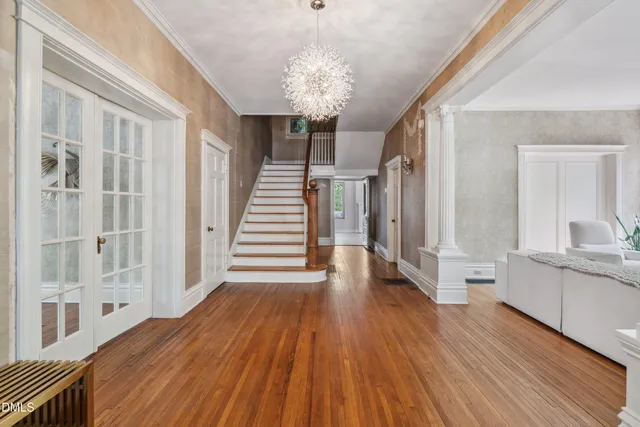 a view of a hallway with wooden floor and staircase