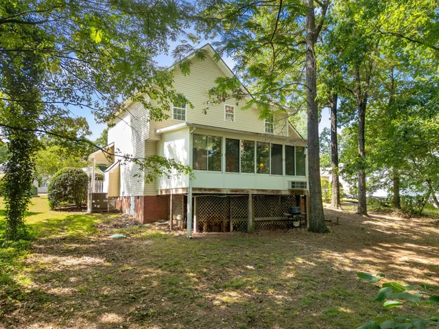 a view of house with a yard