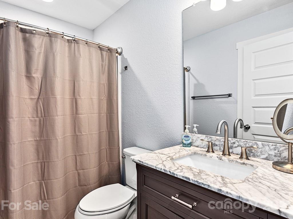 85 Dry Ridge Canton, NC 28716 - Photo 12 of 18 a bathroom with a granite countertop sink toilet and shower