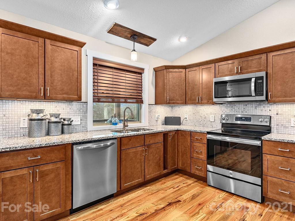 85 Dry Ridge Canton, NC 28716 - Photo 6 of 18 a kitchen with stainless steel appliances granite countertop a sink stove microwave and cabinets