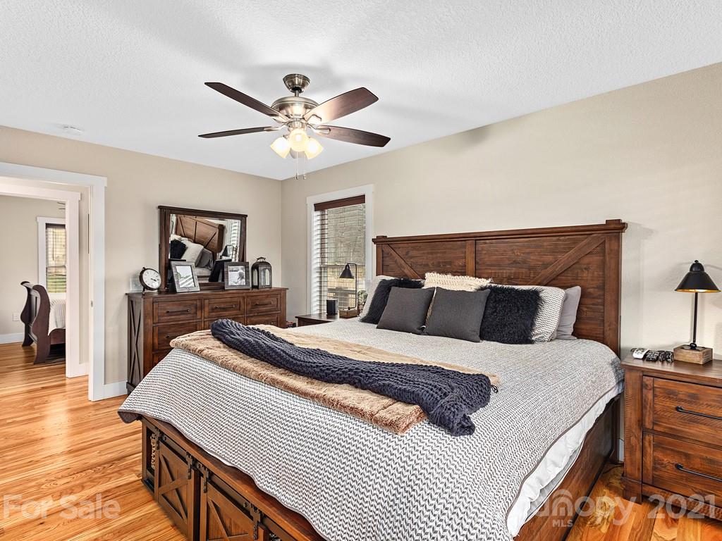 85 Dry Ridge Canton, NC 28716 - Photo 8 of 18 a bedroom with a bed and a chandelier