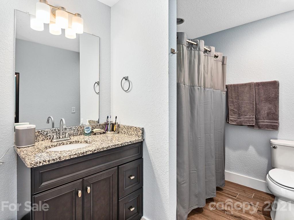 85 Dry Ridge Canton, NC 28716 - Photo 10 of 18 a bathroom with a granite countertop sink toilet and shower