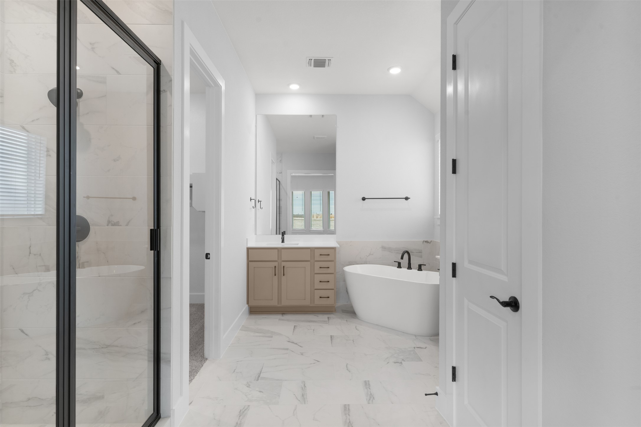 2212 Tobiano Trace Georgetown, TX 78633 - Photo 17 of 26 a bathroom with a bathtub sink mirror and toilet