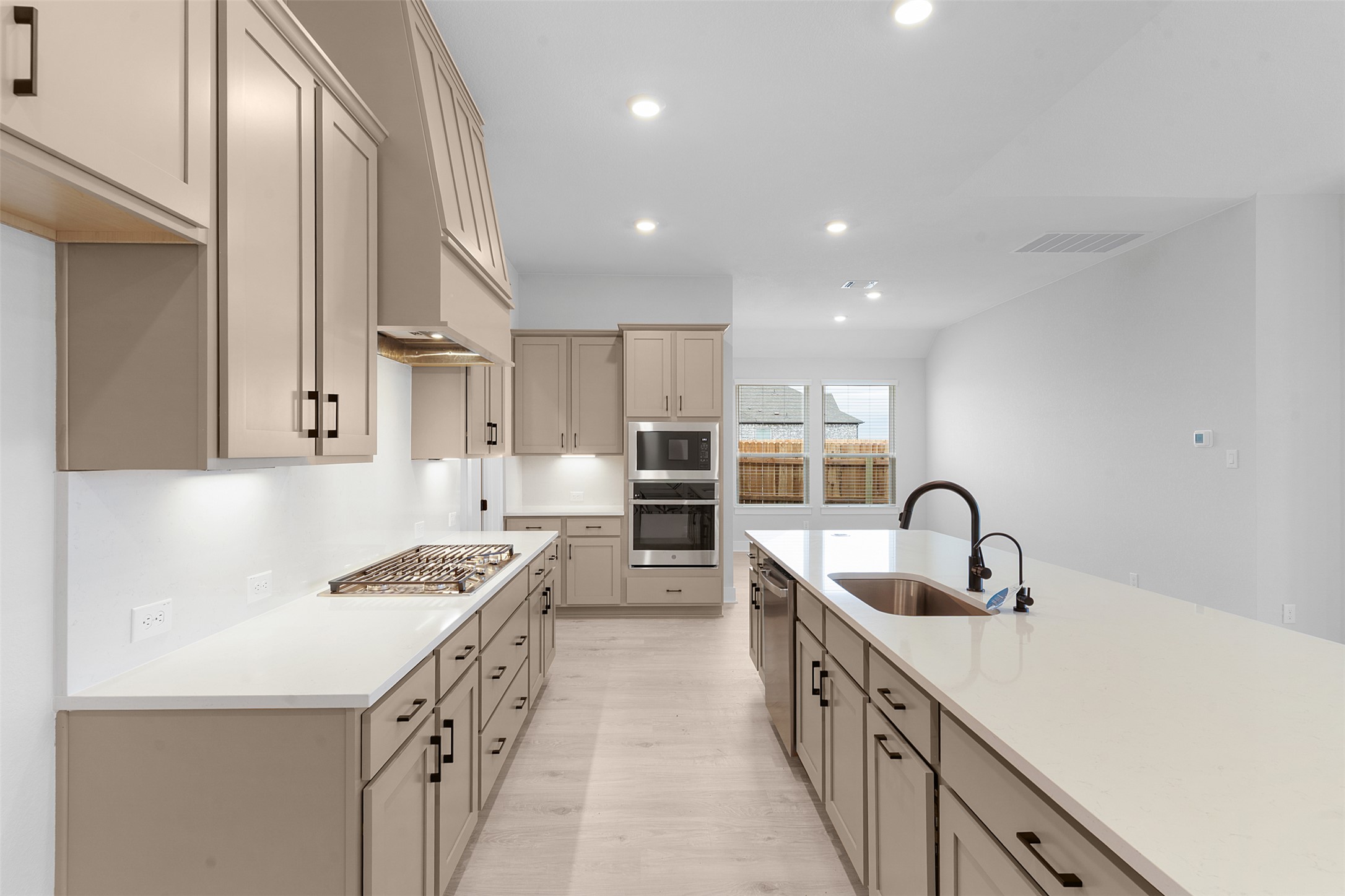 2212 Tobiano Trace Georgetown, TX 78633 - Photo 9 of 26 a kitchen with counter top space a sink stainless steel appliances and cabinets