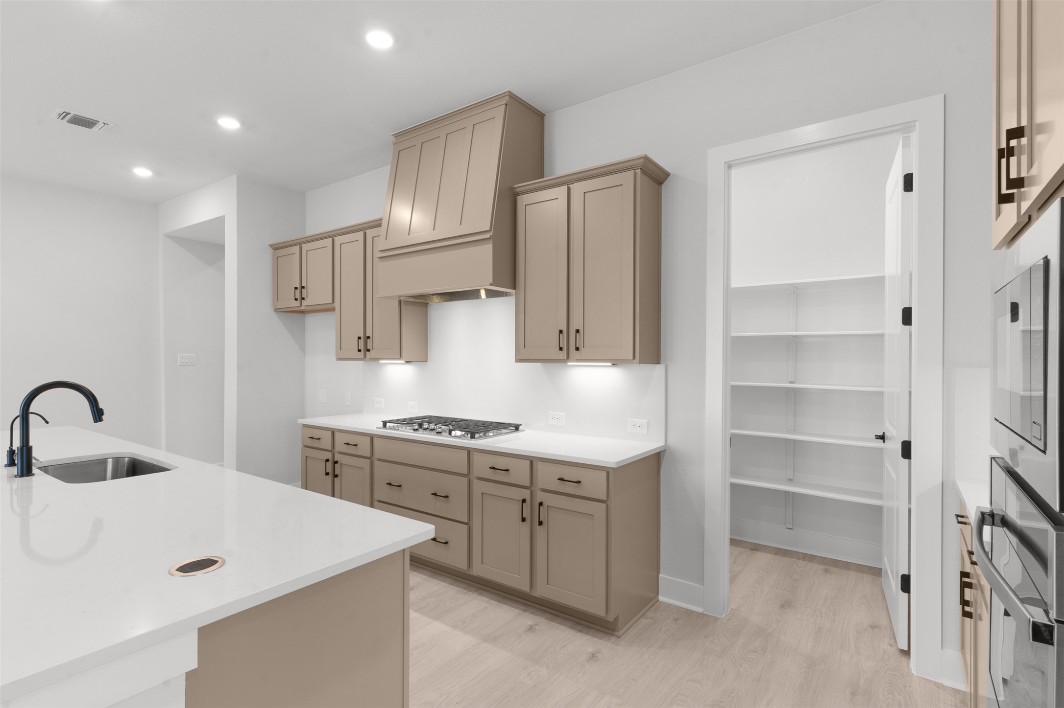 2212 Tobiano Trace Georgetown, TX 78633 - Photo 10 of 26 a kitchen with kitchen island a sink appliances and cabinets