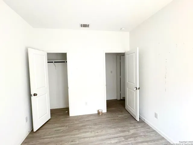 a view of hallway with wooden floor