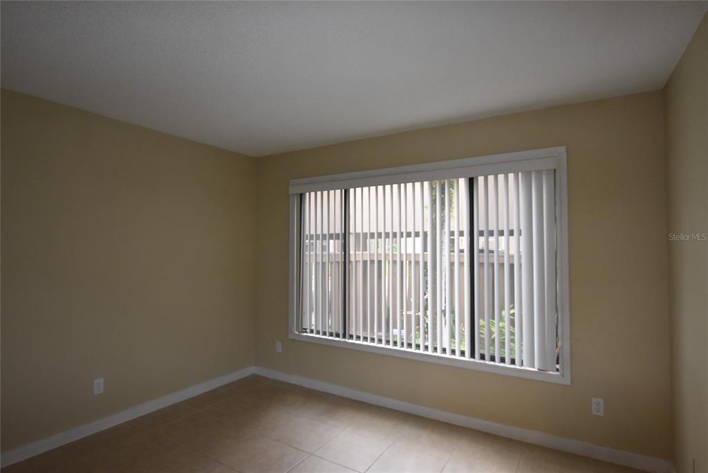 5323 Indian Creek Drive, Unit D Orlando, FL 32811 - Photo 20 of 23 an empty room with a window