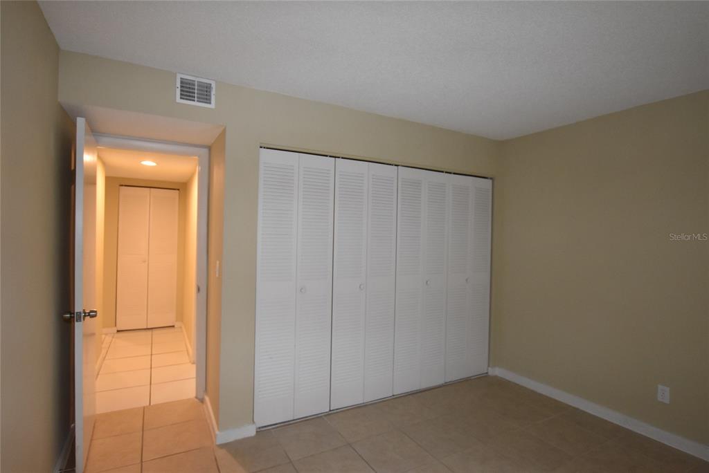 5323 Indian Creek Drive, Unit D Orlando, FL 32811 - Photo 21 of 23 an empty room with closet area