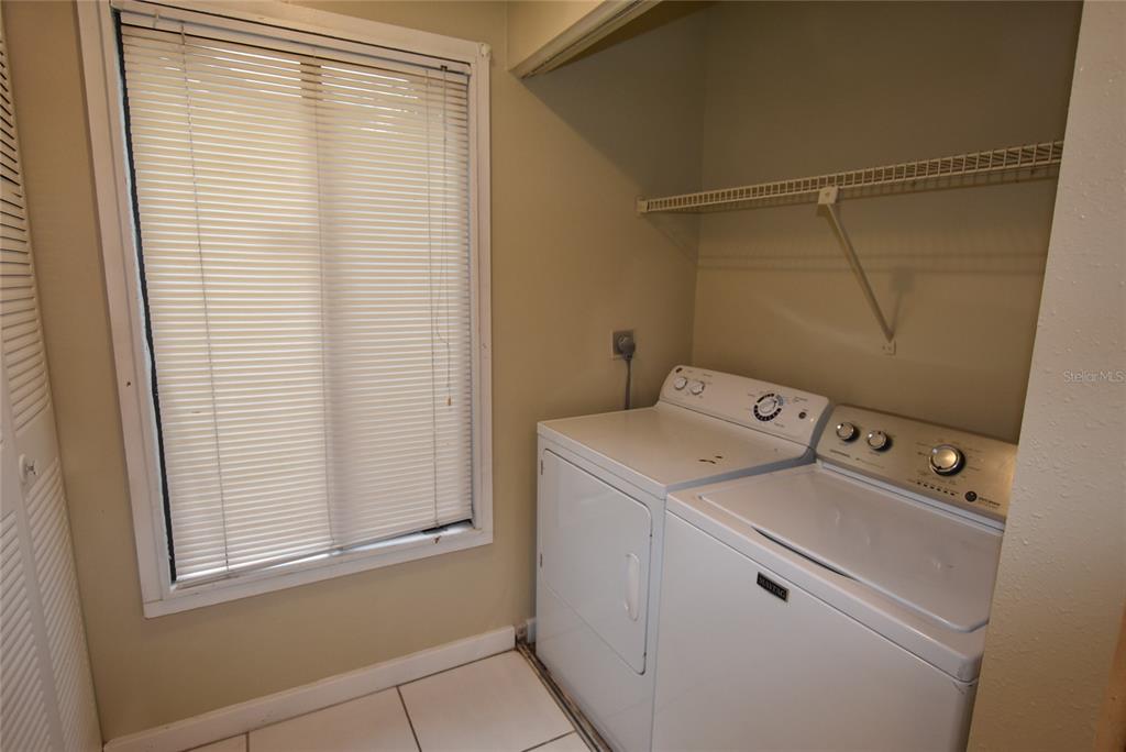 5323 Indian Creek Drive, Unit D Orlando, FL 32811 - Photo 4 of 23 a utility room with dryer and washer