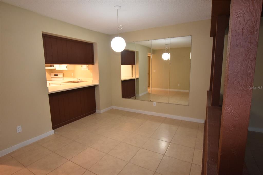 5323 Indian Creek Drive, Unit D Orlando, FL 32811 - Photo 7 of 23 an empty room with wooden floor and windows
