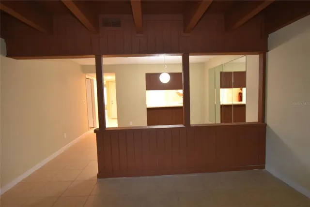 a view of an empty room with large windows