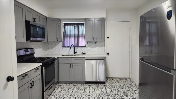 a kitchen with a sink stove and refrigerator
