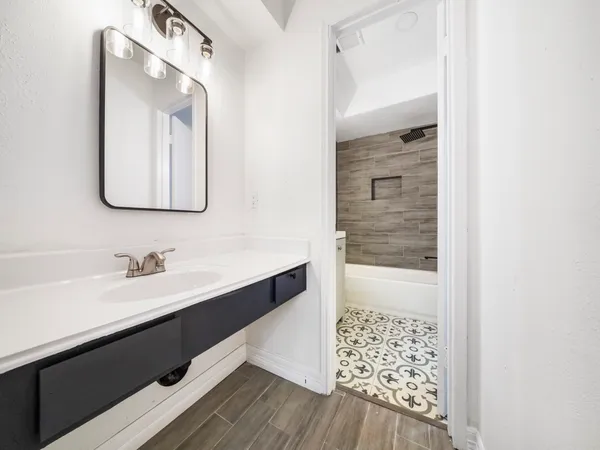 a bathroom with a sink a vanity and a mirror