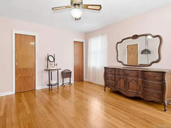 a bathroom with a sink a toilet a mirror and bathtub