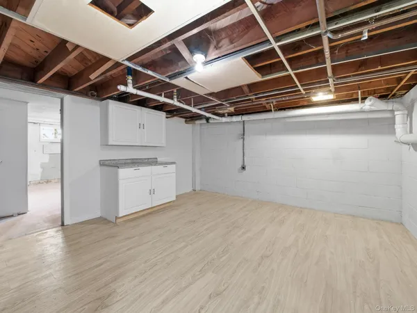 a picture of floor with a white wall and a painting