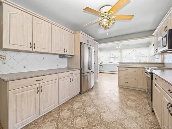 a kitchen with cabinets and stainless steel appliances