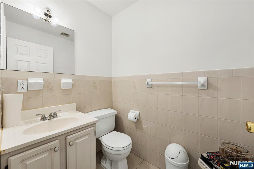 84 Union Street Newark, NJ 07105 - Photo 19 of 39 a bathroom with a sink a toilet and a mirror