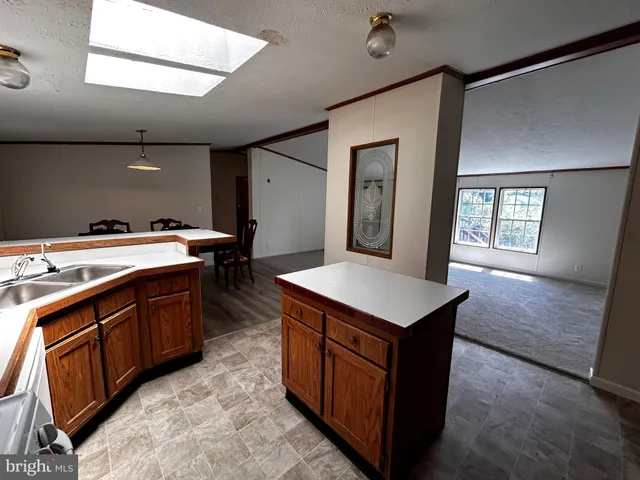 a kitchen with a stove sink and a refrigerator