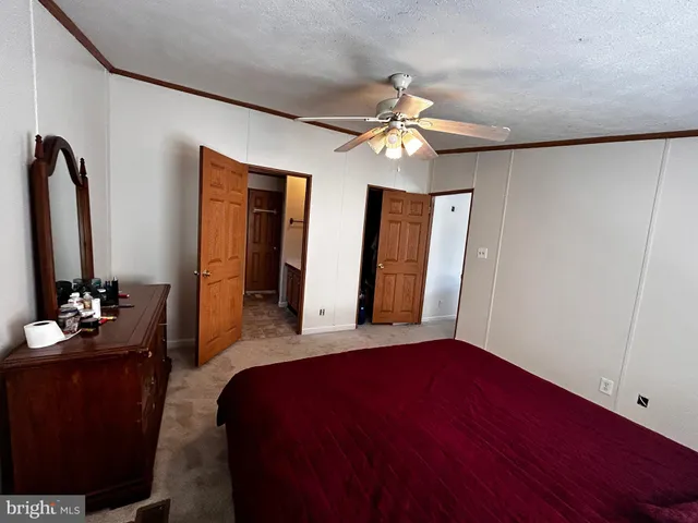 a bedroom with a bed and a mirror