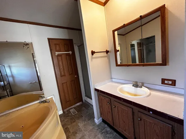 a bathroom with a sink a mirror and bathtub