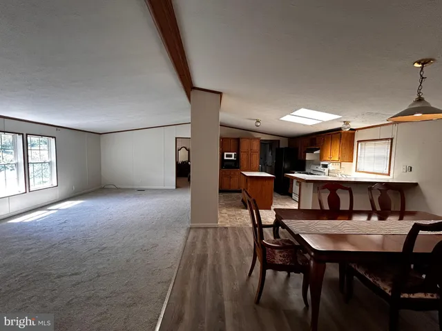 a view of a dining room with furniture and a rug