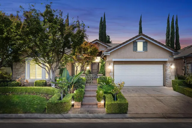 a front view of a house with a yard and garage