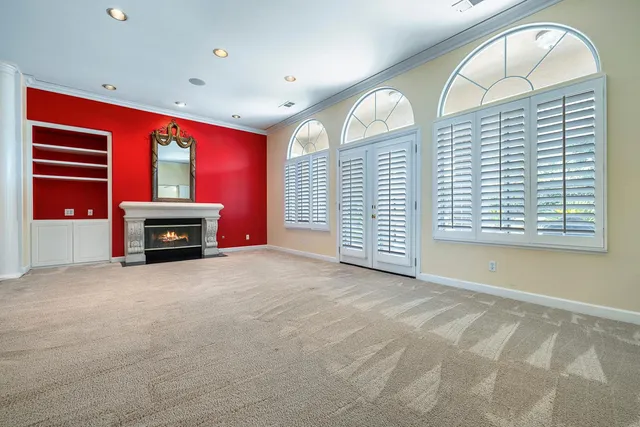 a kitchen with stainless steel appliances granite countertop a refrigerator a sink and white cabinets