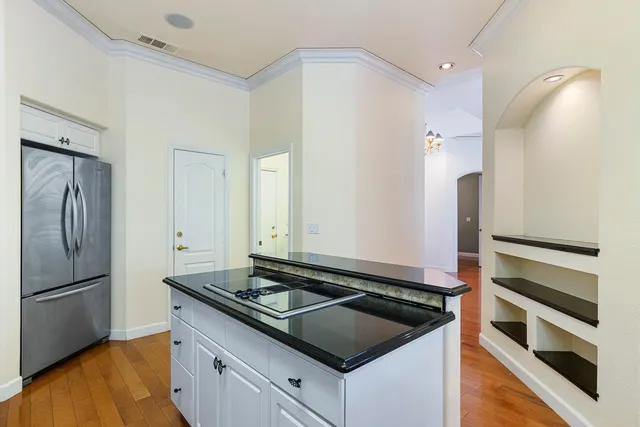 a kitchen with stainless steel appliances granite countertop a sink and cabinets