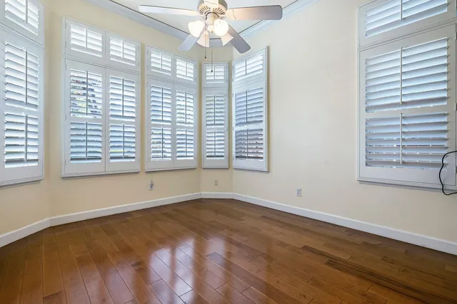 a large white kitchen with wooden floor