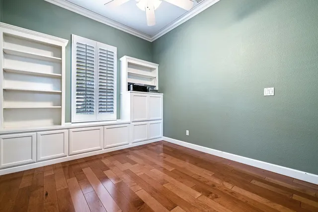 a view of a room with wooden floor