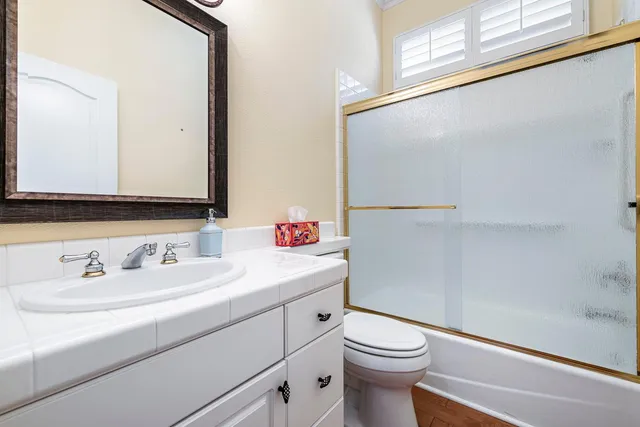 a view of a livingroom with a ceiling fan and window