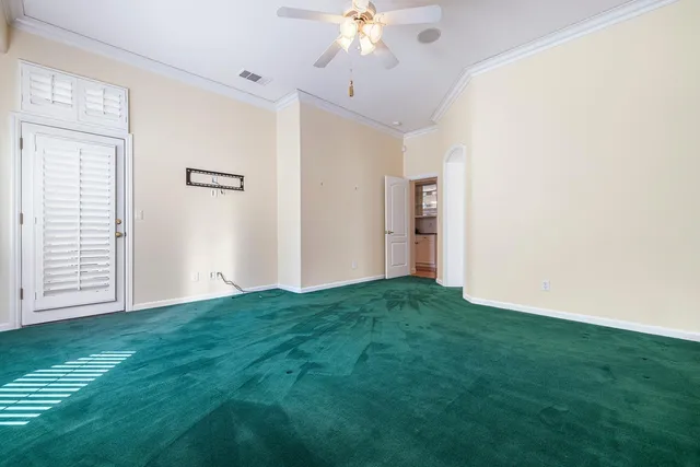 a view of a big room with a chandelier fan and a fireplace