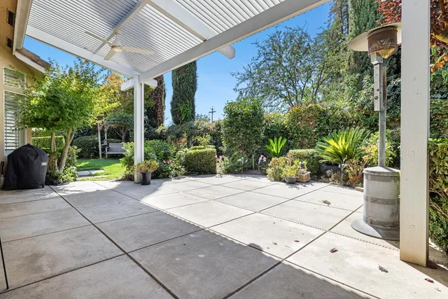a view of a patio with table and chairs potted plants